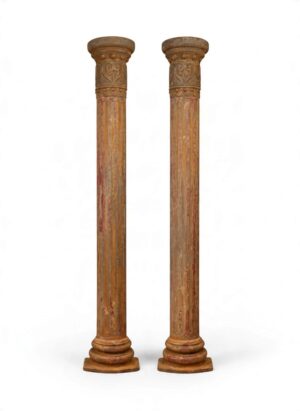 Pair of English Victorian cast iron architectural columns, c.1880–1900, featuring tall fluted shafts, ornate capitals with scrolling foliate decoration, raised bosses and geometric detailing, moulded bases and beautifully weathered historic red, ochre and grey painted surfaces.