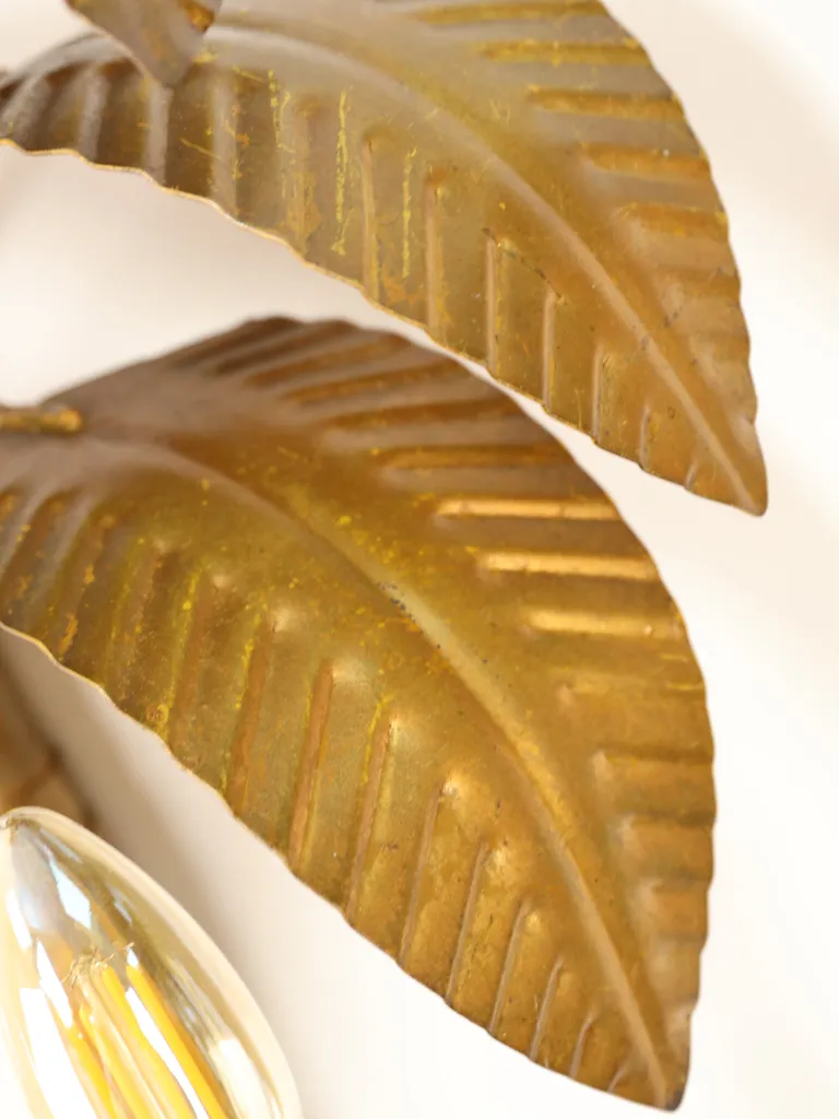 Pair of French gilt metal palm tree wall lights attributed to Maison Jansen, circa 1960, featuring sculptural tropical foliage, textured trunks, elegant twin candle arms and an aged gilt finish.